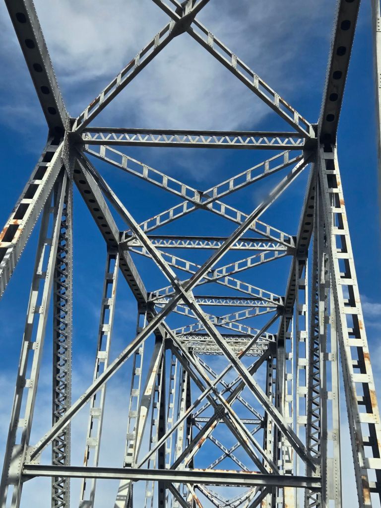 Roadway passing through a steel truss bridge