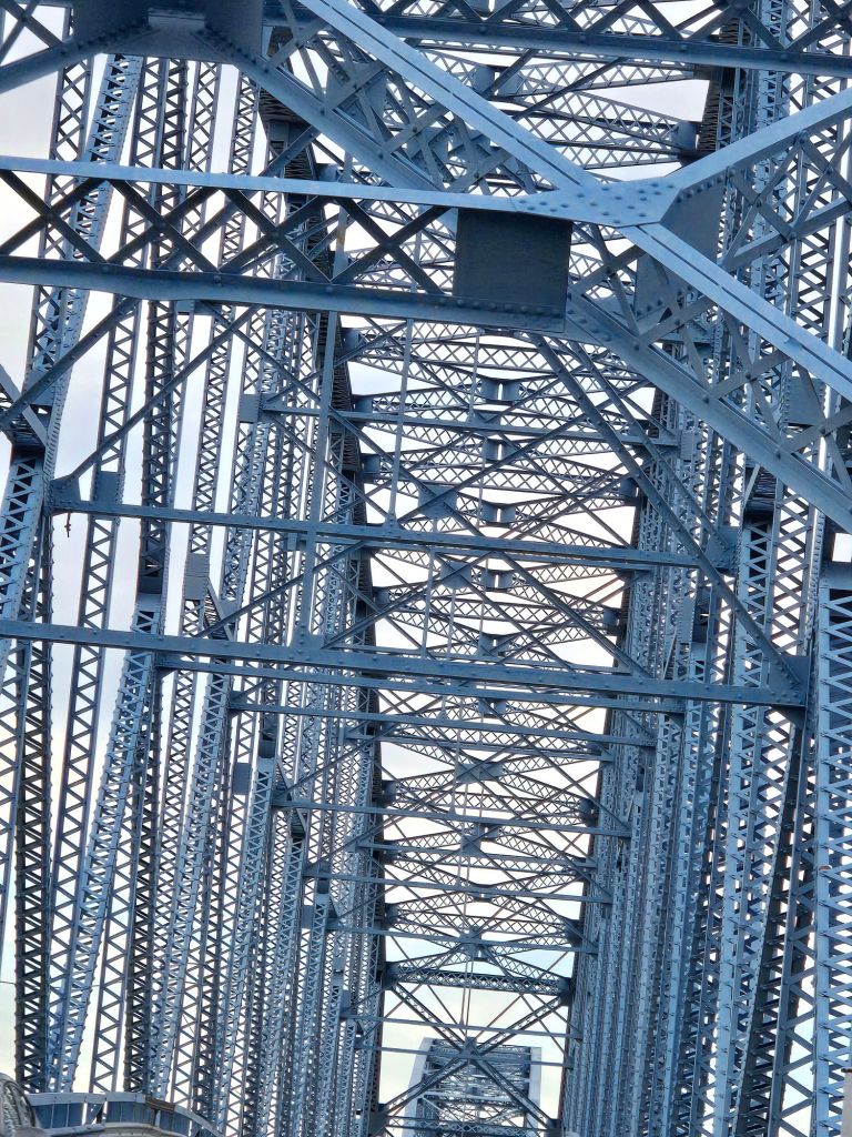 Tall cable-stayed bridge towers and cables against blue sky
