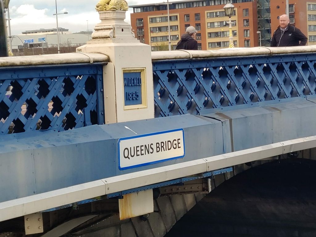 Bridge spanning water near buildings