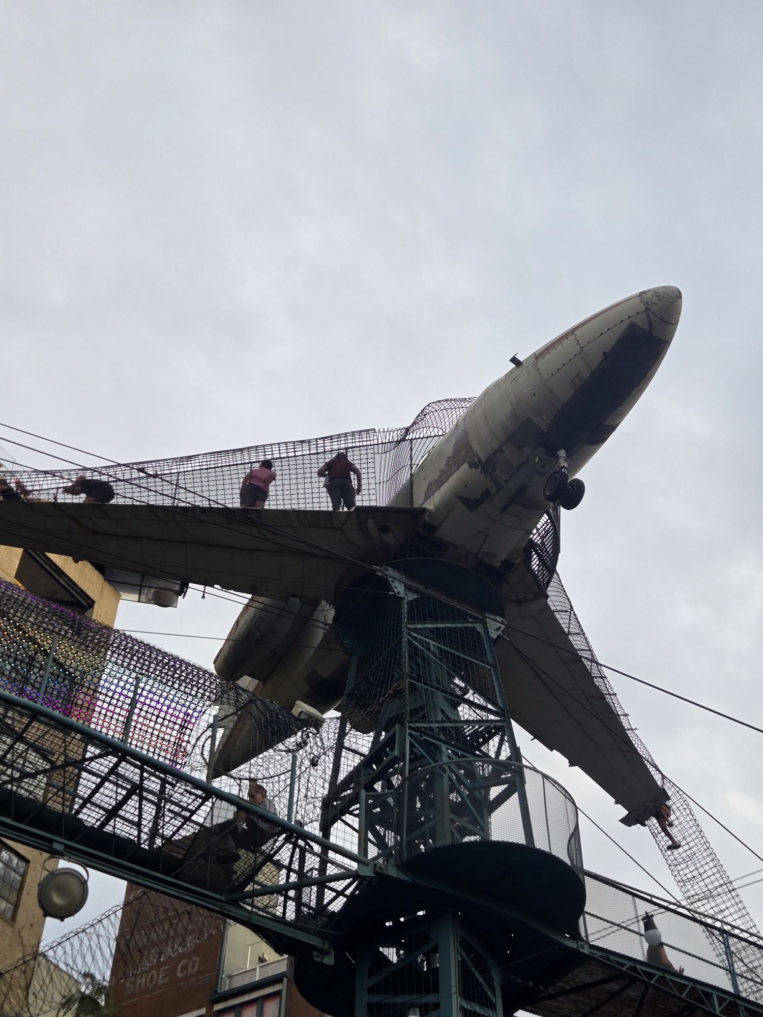 Airplane suspended above the outdoor climbing structures at City Museum in St. Louis.