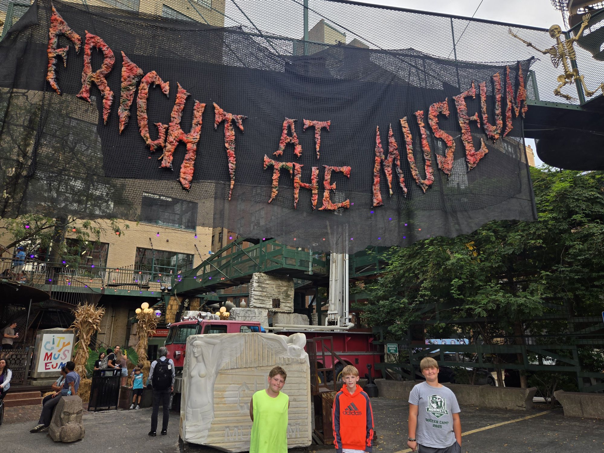 Glowing Halloween jack-o'-lantern decorations and skeleton inside City Museum.