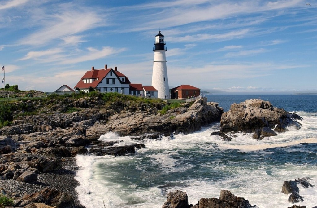 Portland Head Light lighthouse and keeper's house above rocky Atlantic coastline in Cape Elizabeth, Maine
