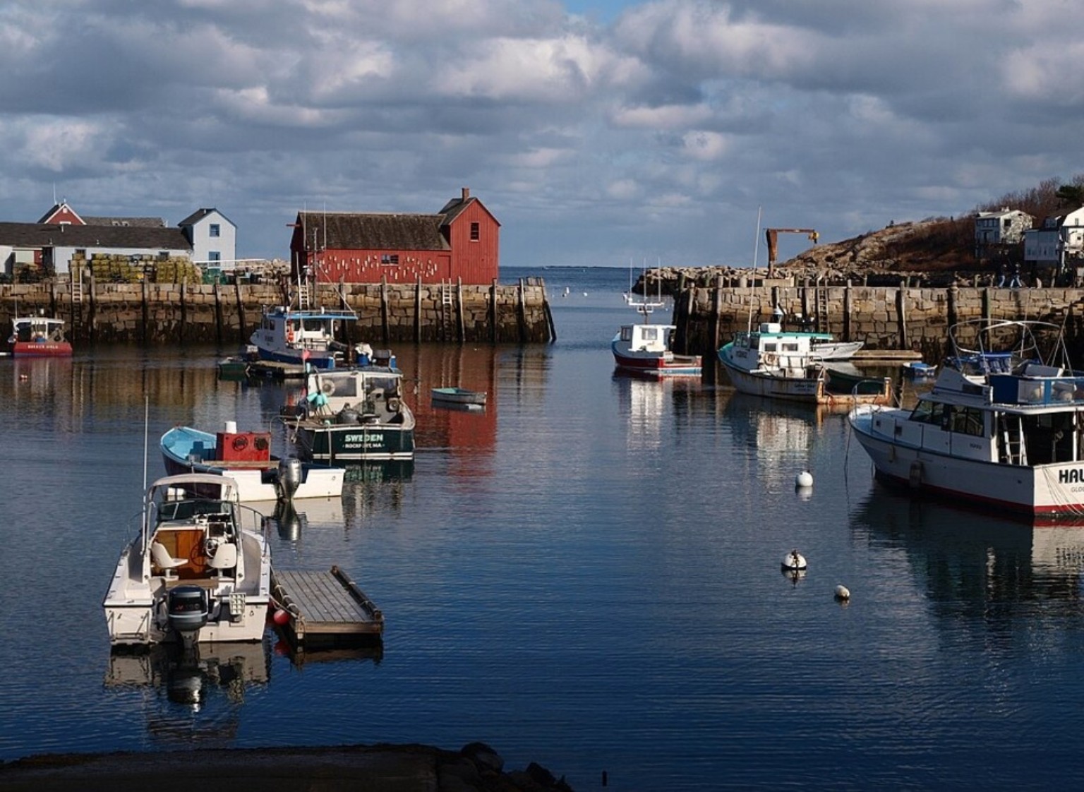 Fishing boats in Rockport Harbor with the red Motif Number 1 shack.