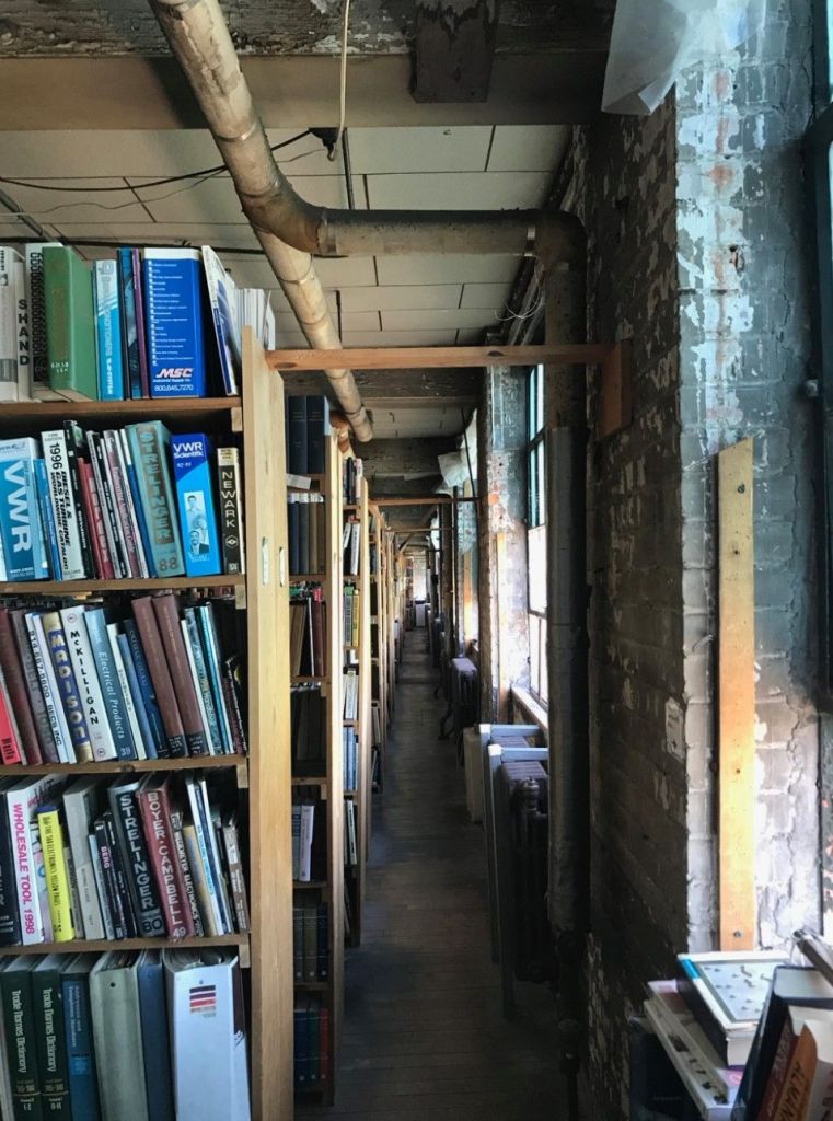 A narrow aisle lined with books at John K. King Used & Rare Books in Detroit.
