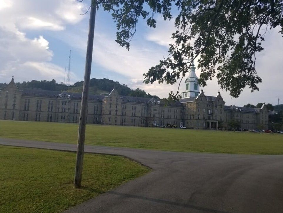 The historic Trans-Allegheny Lunatic Asylum across a lawn in Weston, West Virginia.