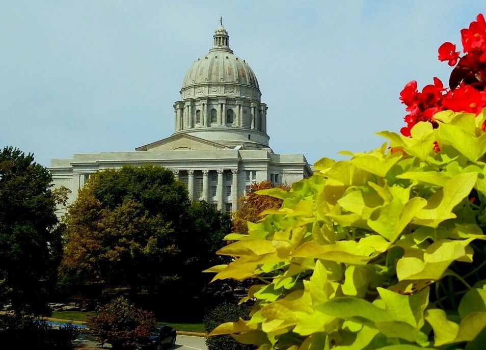 The Missouri State Capitol seen behind garden flowers in Jefferson City.
