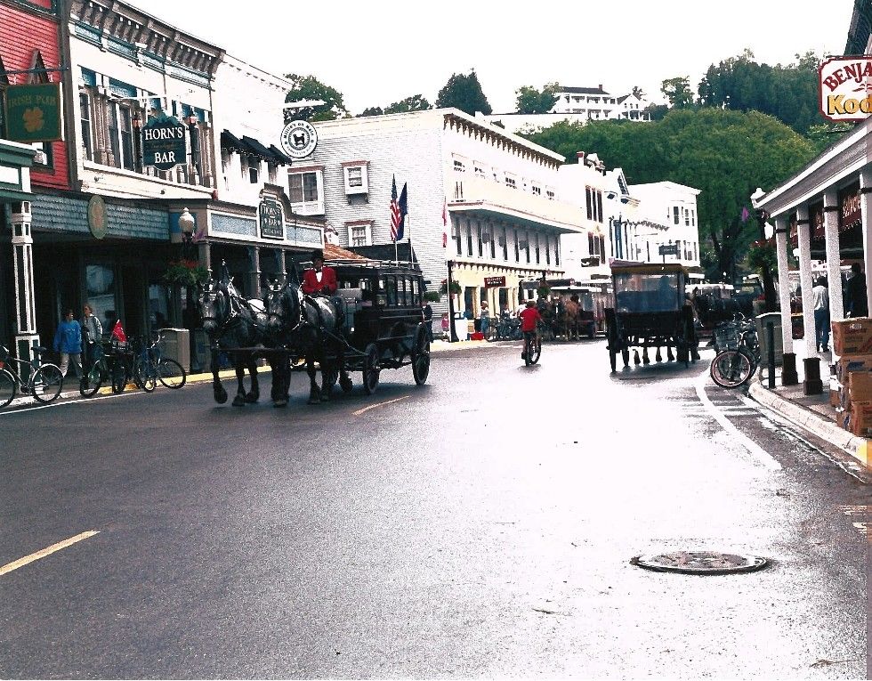 Horse-drawn carriages along Main Street on Mackinac Island, Michigan.