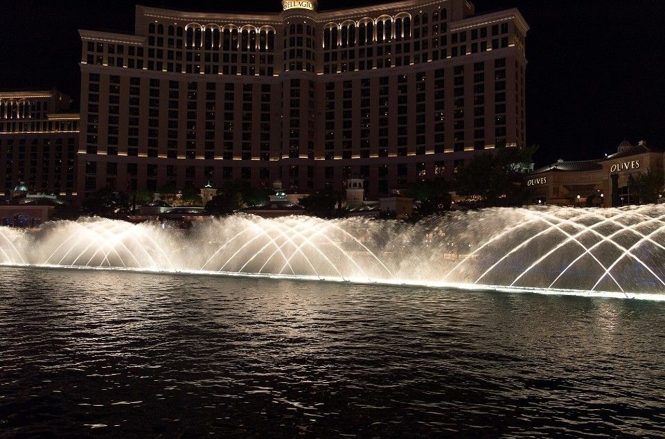 The illuminated Bellagio fountains performing at night in Las Vegas.