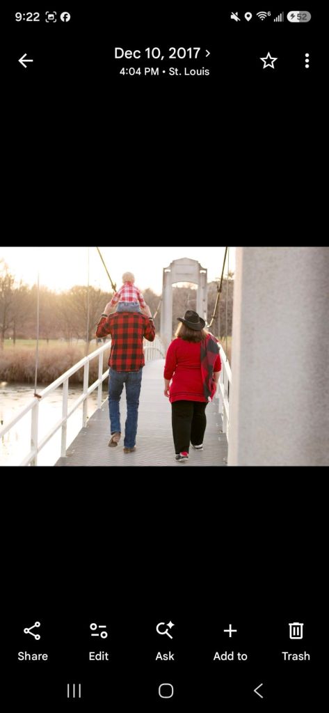 Child standing on a wooden suspension footbridge