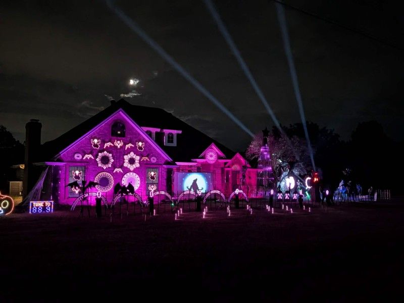 Neumann family Halloween light show with synchronized colorful lighting in Burleson, Texas.